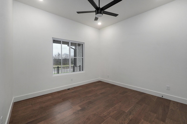 spare room with ceiling fan and dark hardwood / wood-style floors