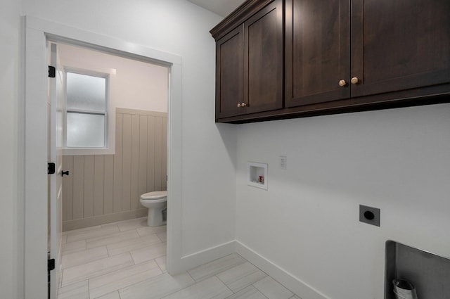 washroom featuring cabinets, hookup for an electric dryer, light tile patterned floors, and washer hookup