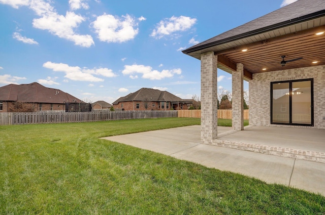 view of yard featuring a patio area and ceiling fan