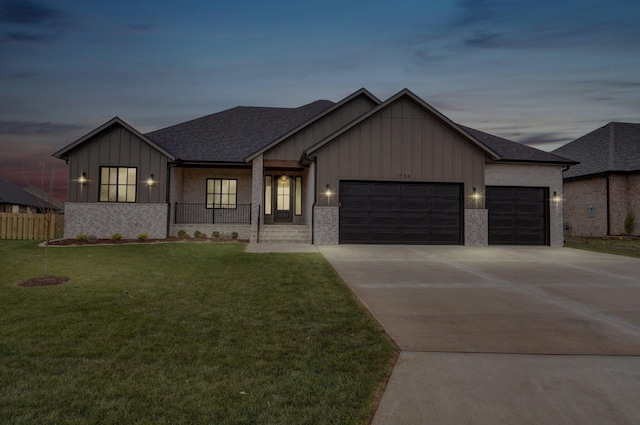 view of front of house with a garage and a yard