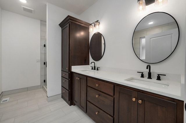 bathroom featuring walk in shower and vanity