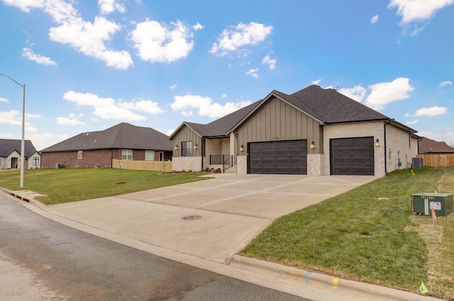 view of front facade featuring a front yard, a garage, and cooling unit