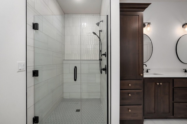 bathroom featuring vanity and a shower with shower door