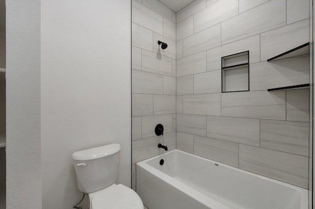 bathroom with tiled shower / bath combo and toilet