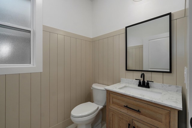 bathroom featuring toilet and vanity