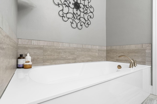 bathroom with a tub to relax in