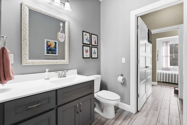 bathroom featuring toilet and vanity