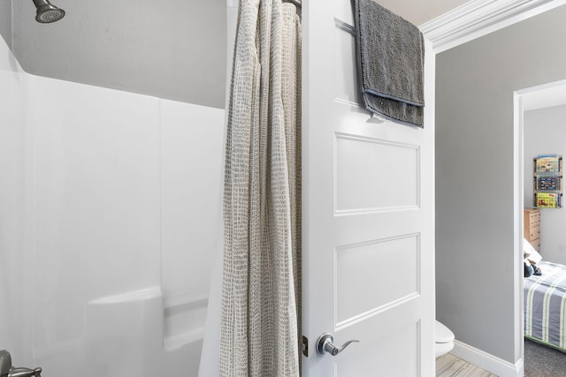 bathroom with curtained shower and toilet