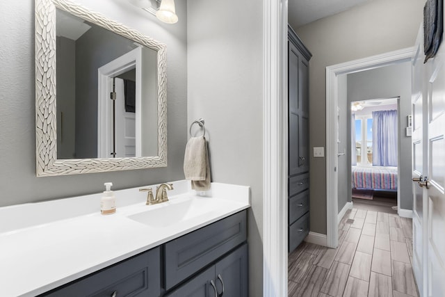 bathroom with ceiling fan and vanity