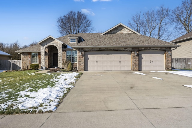 ranch-style house featuring a front yard and a garage