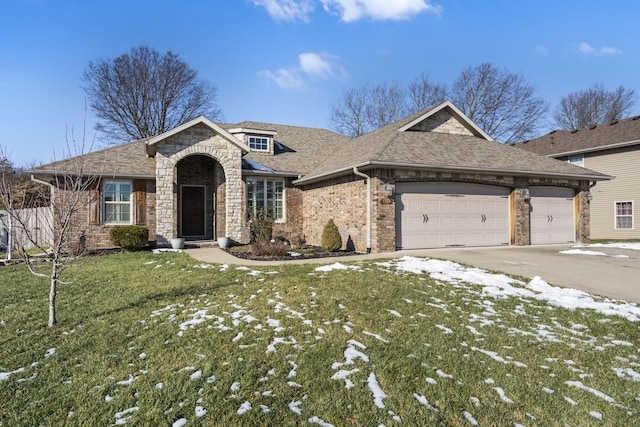 view of front of home featuring a garage and a yard