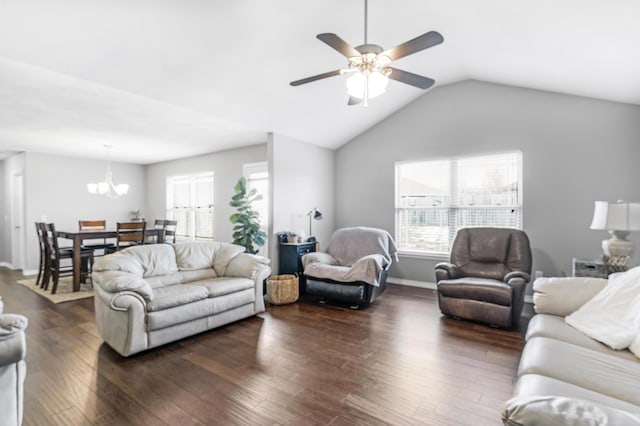 living room with ceiling fan with notable chandelier, dark hardwood / wood-style flooring, and lofted ceiling