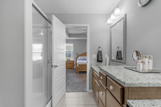 bathroom featuring vanity, walk in shower, and tile patterned flooring