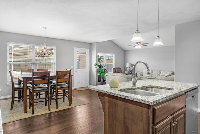 kitchen with sink, an island with sink, stainless steel dishwasher, and a wealth of natural light