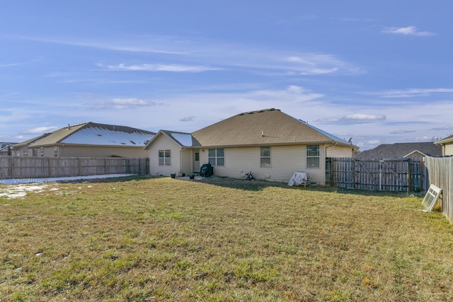 rear view of property with a yard