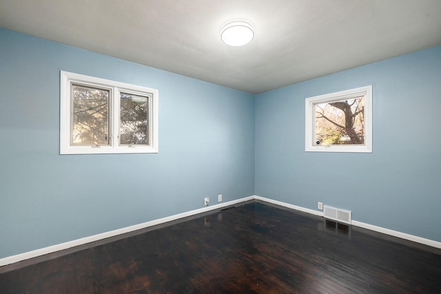 spare room featuring dark hardwood / wood-style floors