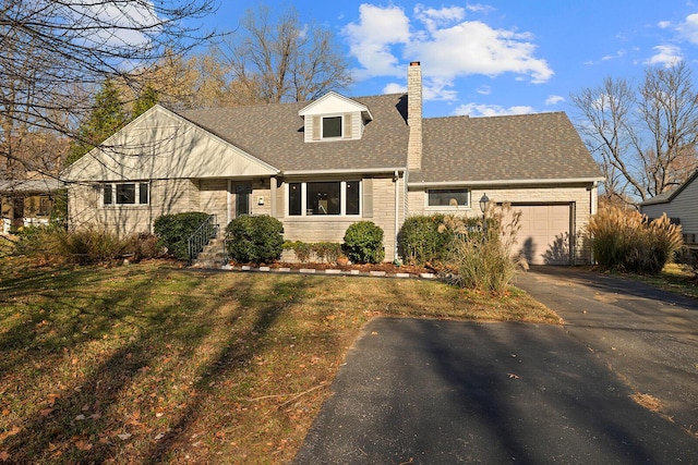 cape cod home with a garage and a front lawn