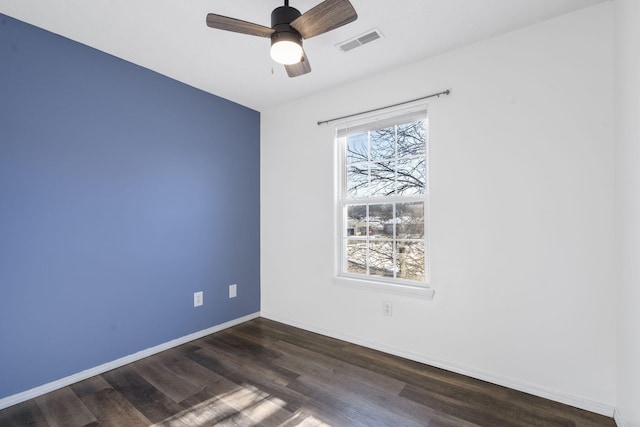 empty room with ceiling fan and dark hardwood / wood-style floors