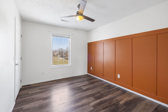 unfurnished bedroom featuring a textured ceiling, ceiling fan, a closet, and dark hardwood / wood-style floors