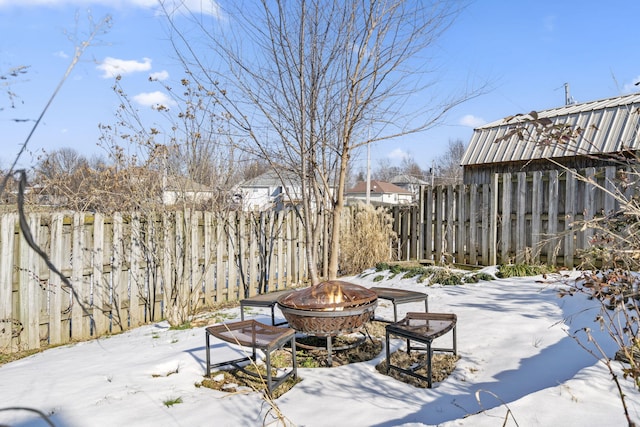 snowy yard featuring a fire pit