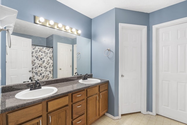 bathroom with vanity and curtained shower