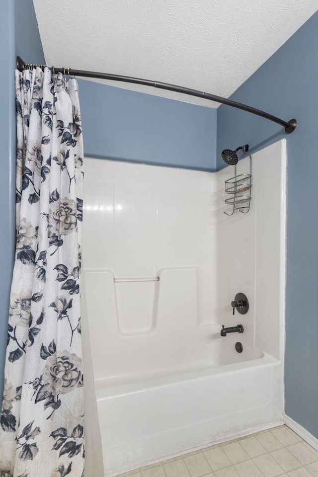 bathroom with shower / tub combo, tile patterned floors, and a textured ceiling