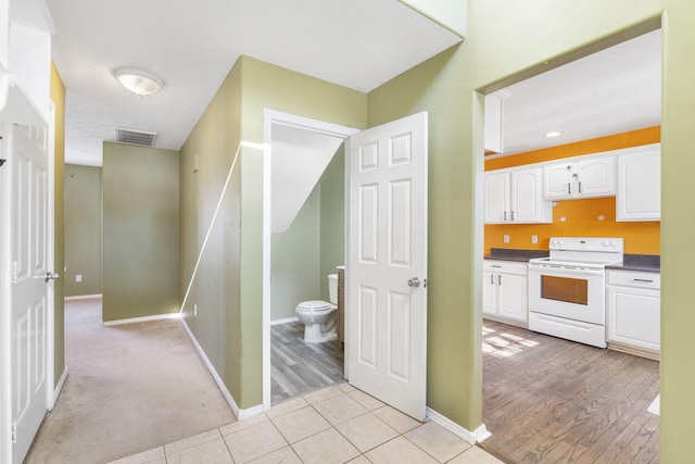 hall featuring light tile patterned flooring