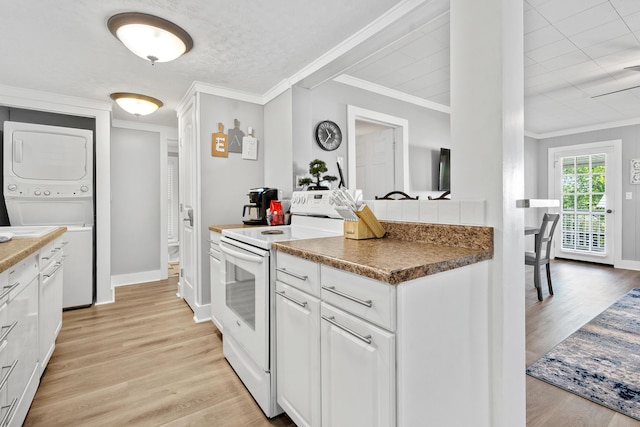 kitchen with ornamental molding, white cabinets, stacked washer and clothes dryer, and white electric range