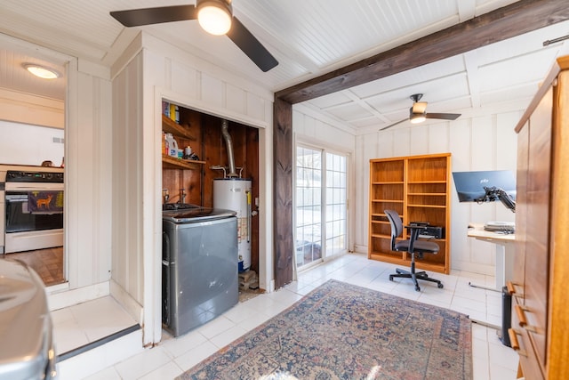 home office with washer / dryer, wood walls, ceiling fan, light tile patterned floors, and gas water heater