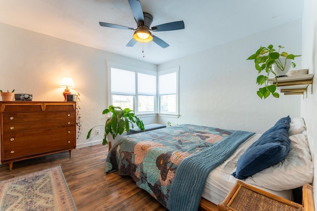 bedroom with ceiling fan and dark hardwood / wood-style flooring