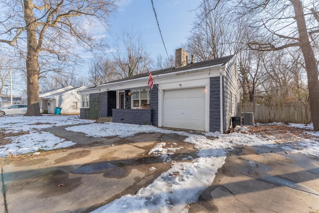 view of front facade featuring a garage, central AC unit, and a porch