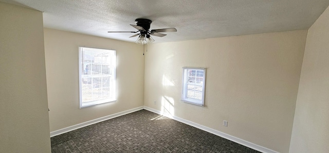 empty room with ceiling fan and a healthy amount of sunlight