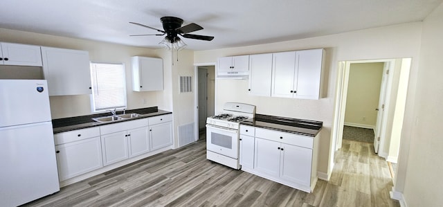 kitchen featuring white appliances, light hardwood / wood-style floors, ceiling fan, sink, and white cabinetry