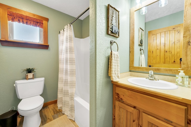 full bathroom with vanity, toilet, shower / bath combo with shower curtain, and hardwood / wood-style flooring