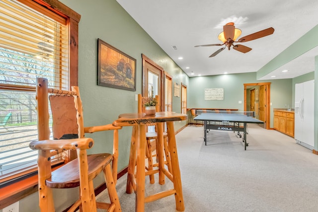 playroom featuring light carpet and ceiling fan