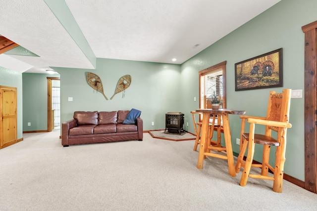 carpeted living room featuring a wood stove