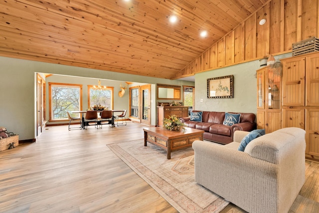 living room featuring wood ceiling, light wood-type flooring, an inviting chandelier, and high vaulted ceiling