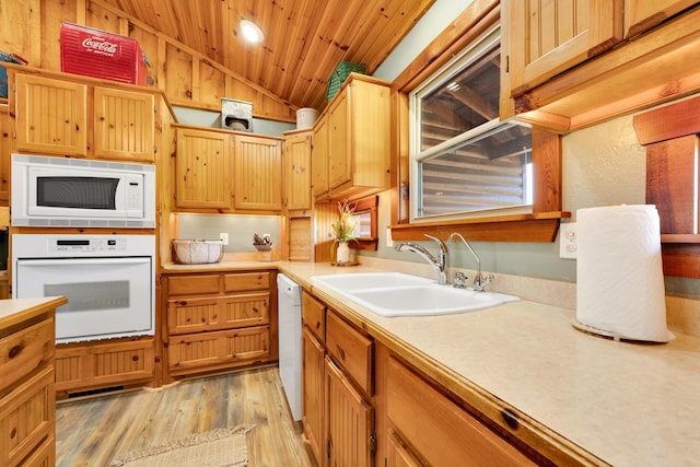 kitchen featuring white appliances, wood ceiling, light wood-type flooring, sink, and lofted ceiling