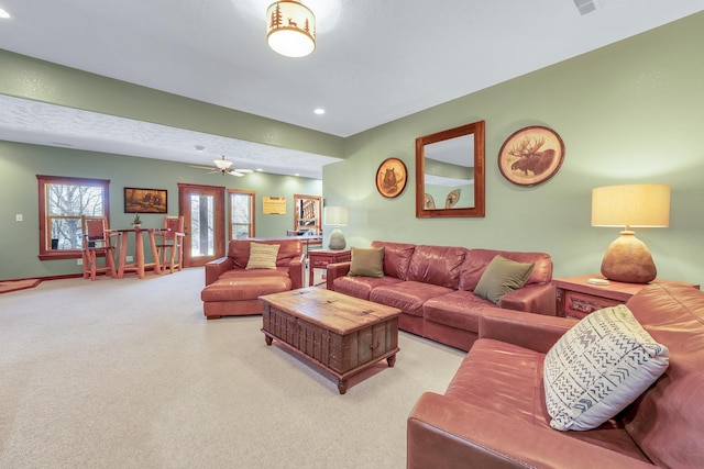 living room featuring light colored carpet and ceiling fan