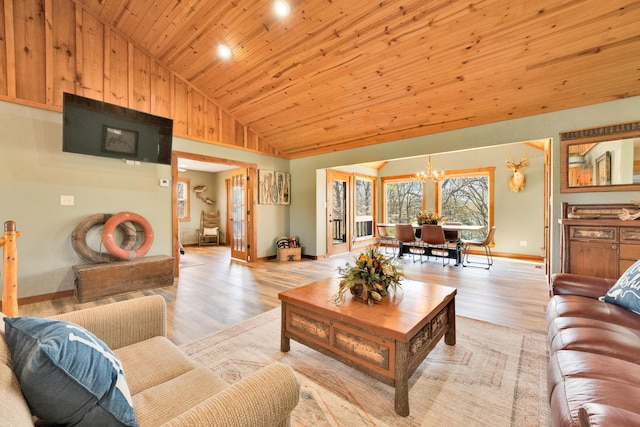 living room with a notable chandelier, wood ceiling, light wood-type flooring, and high vaulted ceiling