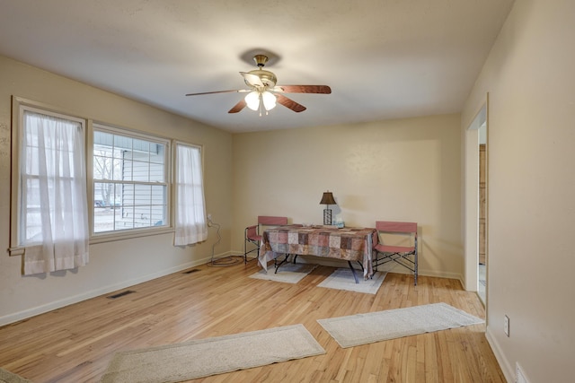 dining area with light hardwood / wood-style floors and ceiling fan