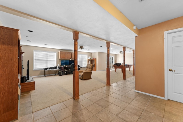 basement featuring ceiling fan and light carpet