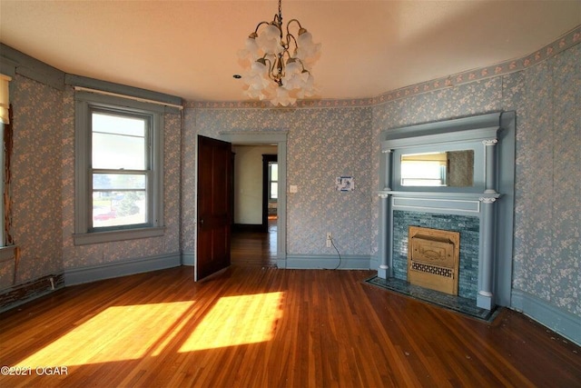 unfurnished living room featuring hardwood / wood-style flooring and a notable chandelier