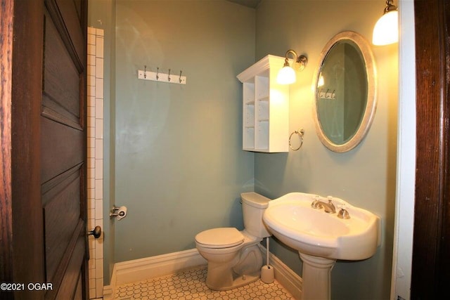 bathroom with sink, tile patterned floors, and toilet