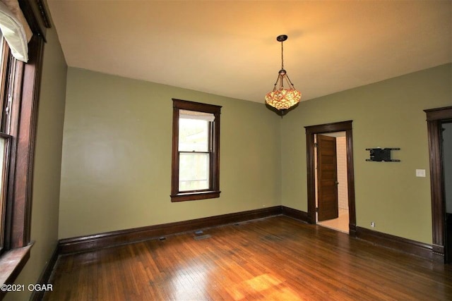 empty room featuring dark hardwood / wood-style flooring