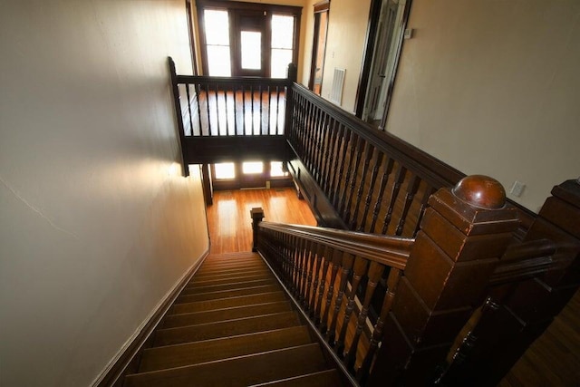 stairs with hardwood / wood-style flooring