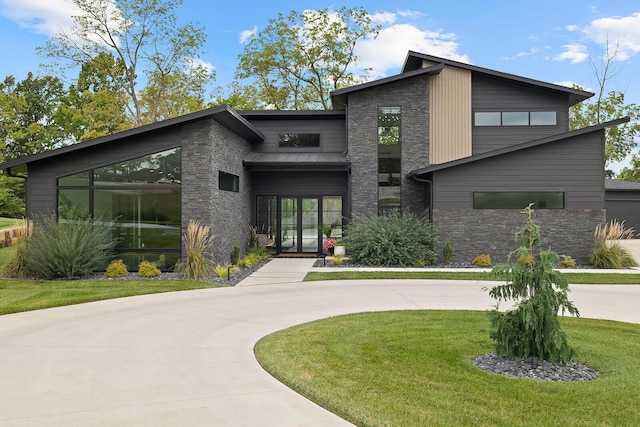 view of front facade featuring stone siding and a front yard