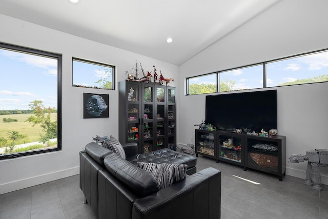 living area featuring vaulted ceiling, recessed lighting, and baseboards