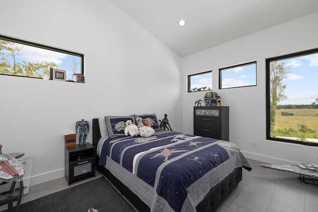 bedroom featuring high vaulted ceiling, recessed lighting, and baseboards