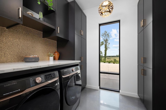 laundry room with cabinets and washer and clothes dryer